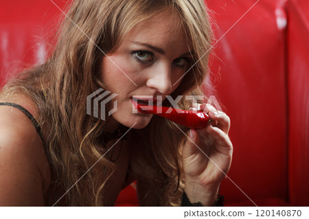 Sensual woman holding hot red chilli pepper Sensual woman holding hot red chilli pepper 120140870