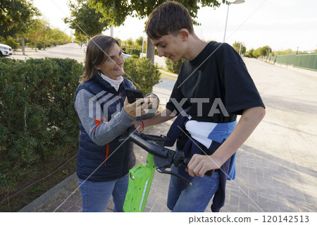 Engaging Conversation Between Woman and Teen on Scooter Engaging Conversation Between Woman and Teen on Scooter 120142513