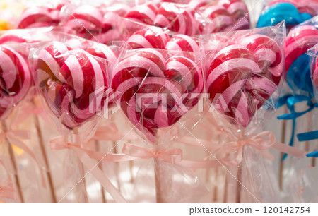 Color lollipop, spiral candy on stick, colorful striped lollypop, round fruit caramel, multicolored confectionery 120142754