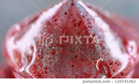 Shiny pyramid. Liquid shimmer texture. Defocused red color sparkling glitter ink drip prism shape abstract art background with bokeh lights. Shiny pyramid. Liquid shimmer texture. Defocused red color sparkling glitter ink drip prism shape abstract art background with bokeh lights. 120143362
