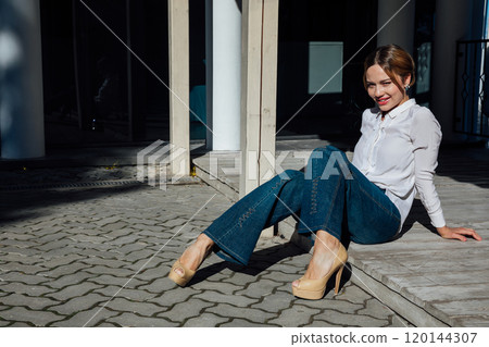 Portrait of a beautiful slender fashion woman in a blouse and skirt on a street walk Portrait of a beautiful slender fashion woman in a blouse and skirt on a street walk 120144307