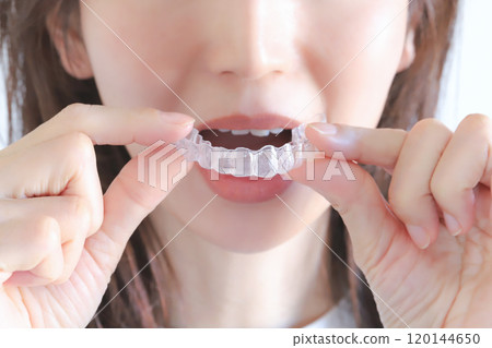 A woman wearing a dental mouthpiece A woman wearing a dental mouthpiece 120144650
