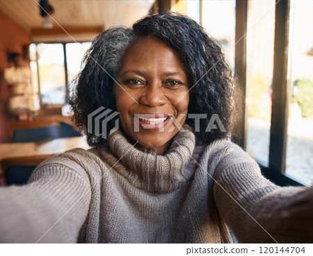 Happy Moments in Coffee Shop Mature Woman Influencer Vlogging or Taking Selfie in Coffee Shop 120144704
