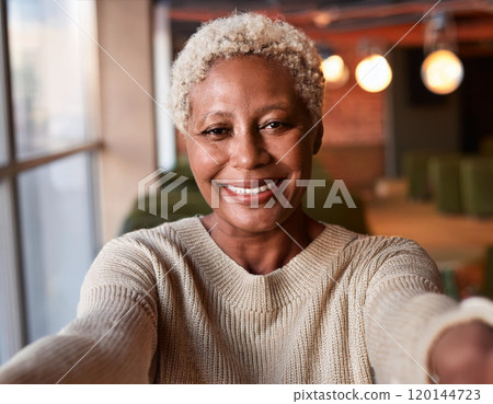Happy Moments in Coffee Shop Mature Woman Influencer Vlogging or Taking Selfie in Coffee Shop 120144723