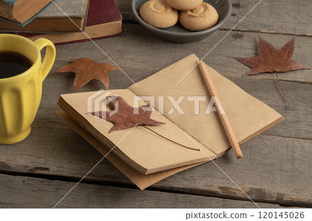 blank notebook on wooden table with autumn leaves blank notebook on wooden table with autumn leaves 120145026