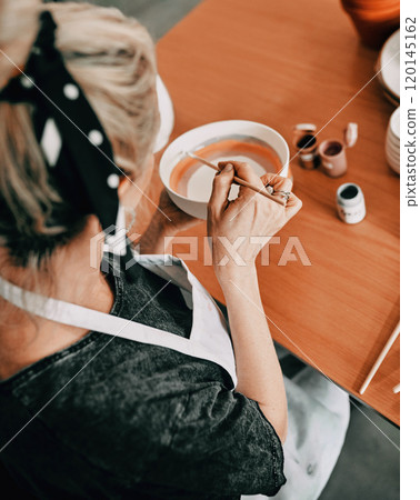 I was created to create. High angle shot of an unrecognizable woman sitting alone and painting a pottery bowl in her workshop. I was created to create. High angle shot of an unrecognizable woman sitting alone and painting a pottery bowl in her workshop. 120145162
