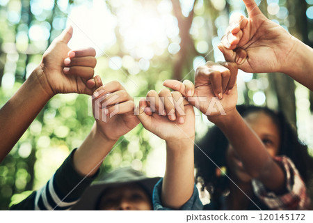 Friends forever to the camp and back. Shot of a group of teenagers linking fingers at summer camp. 120145172