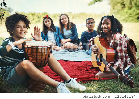 One day these songs will make awesome memories. Shot of a group of teenagers playing musical instruments in nature at summer camp. 120145184