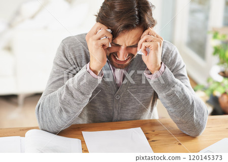 I might just cry. A frustrated businessman with his head in his hands over work stress. 120145373