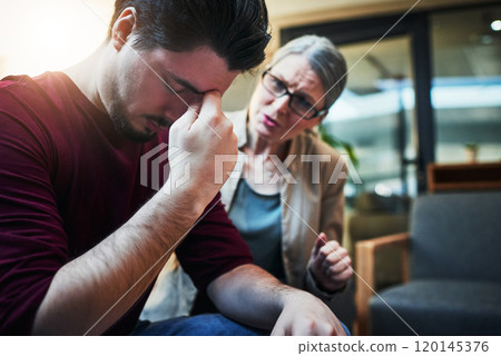 The deepest scars are the ones we dont see. Shot of a young man being comforted by his psychologist during a therapeutic session. The deepest scars are the ones we dont see. Shot of a young man being comforted by his psychologist during a therapeutic session. 120145376