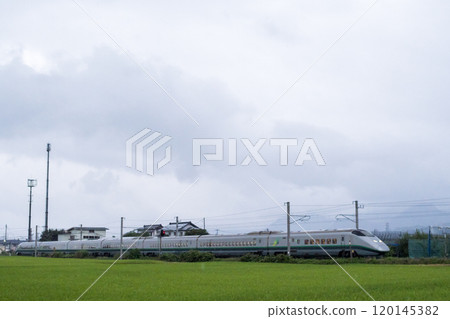[Yamagata Line] Yamagata Shinkansen Tsubasa running through a rural landscape at dusk 120145382