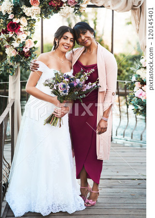 My little princess is getting married today. Full length shot of a happy young bride posing with her mother outdoors on her wedding day. 120145401