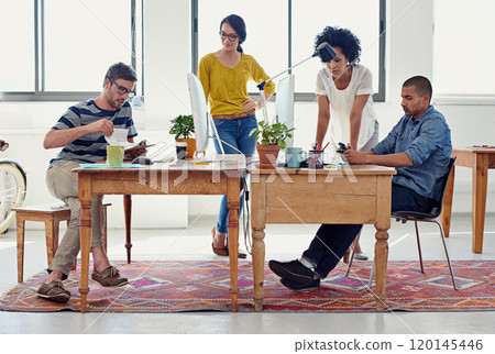 They can design anything. Shot of a group of creative professionals working in an office. 120145446