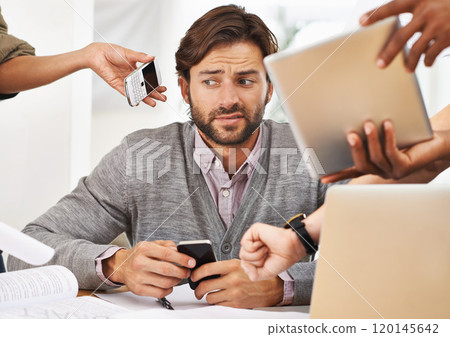 Delegation is key to avoiding burnout. A cropped shot of a handsome businessman with colleagues requesting various things from him. 120145642