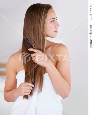 Getting rid of unwanted tangles. A gorgeous brunette woman brushing her healthy long hair. Getting rid of unwanted tangles. A gorgeous brunette woman brushing her healthy long hair. 120145650