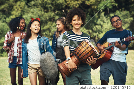 Weve got the best friends at band camp. Shot of a group of teenagers playing musical instruments in nature at summer camp. Weve got the best friends at band camp. Shot of a group of teenagers playing musical instruments in nature at summer camp. 120145715