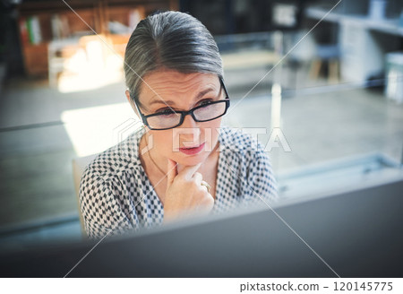 Stay focused, finish stronger. Shot of a mature businesswoman using a computer in a modern office. Stay focused, finish stronger. Shot of a mature businesswoman using a computer in a modern office. 120145775