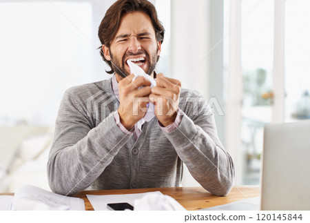 Today is not a good day. A handsome businessman crumpling paper in frustration over work stress. 120145844