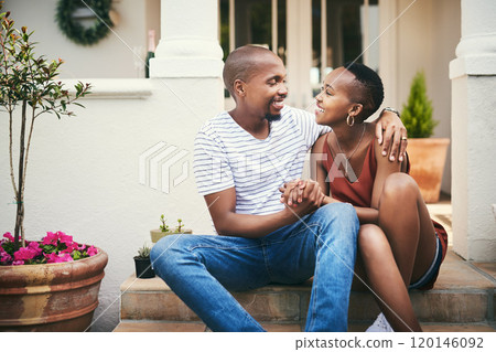 Home is wherever you are, babe. Shot of an affectionate couple sitting on their front door steps. 120146092