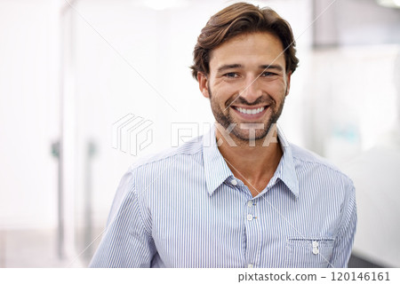Hes a confident young businessman. Portrait of a handsome young businessman standing in his office. 120146161