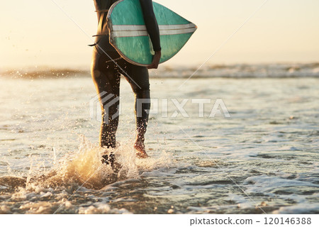 When life give you rough waves, surf them. Rearview shot of an unrecognizable young woman going surfing at the beach. 120146388