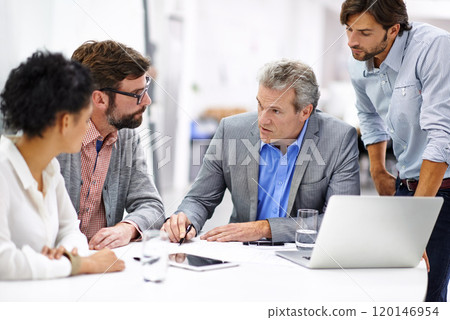 Leading his team through the creative process. Shot of a group of a diverse group of business professionals having a meeting. 120146954