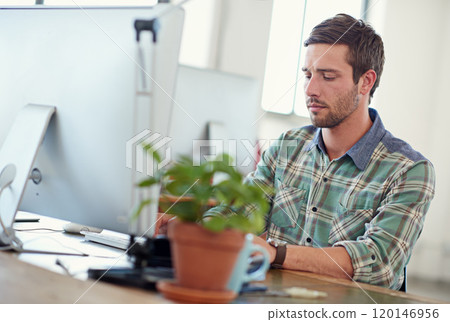 Theres a lot of work to be done. Shot of a casually-dressed young man at work on a computer. 120146956