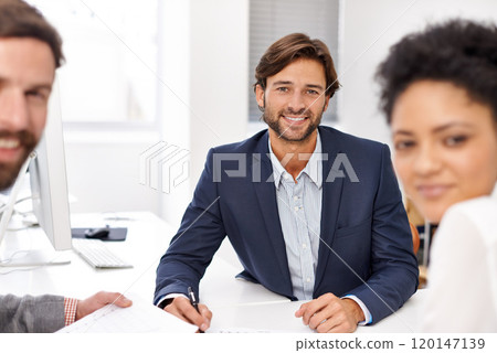 Building their company from the ground up. Portrait of a group of young office professionals going over paperwork. Building their company from the ground up. Portrait of a group of young office professionals going over paperwork. 120147139
