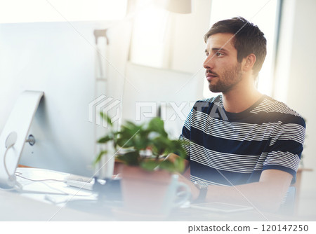 Letting his fingers do the talking. Shot of a designer working at his computer. 120147250
