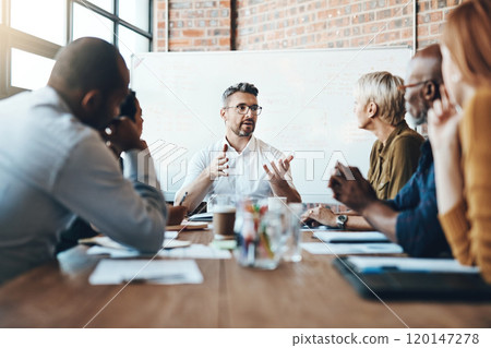 Debating before reaching a decision. Shot of a businessman leading a meeting in the boardroom. 120147278