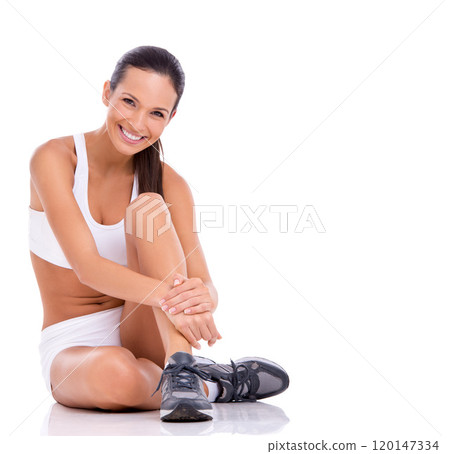Picture perfect health. Studio portrait of an attractive woman in exercise clothing sitting on the floor isolated on white. 120147334