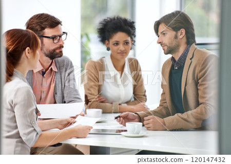 Teamwork gets business done. A group of businesspeople going over some plans together. Teamwork gets business done. A group of businesspeople going over some plans together. 120147432