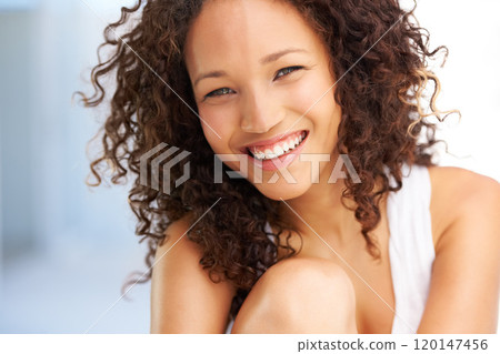 Shes got a bubbly personality. Naturally gorgeous young woman looking at you with a smile. 120147456