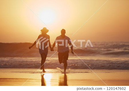 Im ready for my happily ever after. Shot of a mature couple running on the beach. Im ready for my happily ever after. Shot of a mature couple running on the beach. 120147602