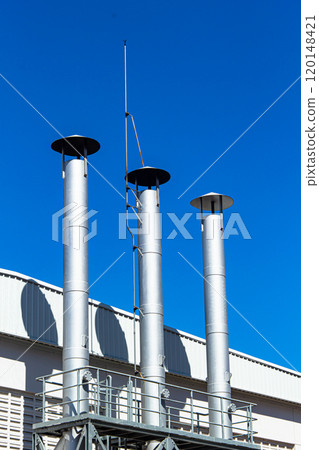 Pipes of the boiler room against the blue sky. Pipes of the boiler room against the blue sky. 120148421