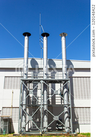 Pipes of the boiler room against the blue sky. Pipes of the boiler room against the blue sky. 120148422