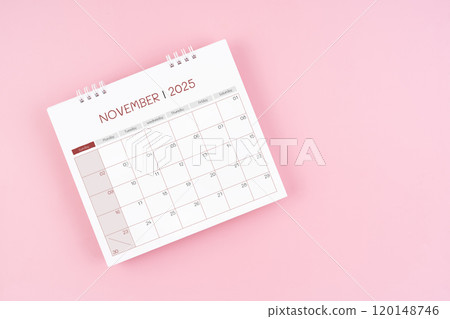 Top view on November desk calendar for 2025 year on pink background. 120148746