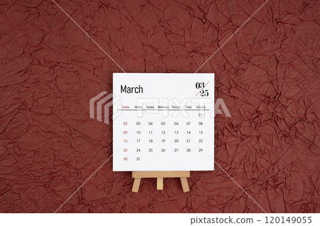 March 2025 calendar on red crumpled paper background. Directly above. 120149055