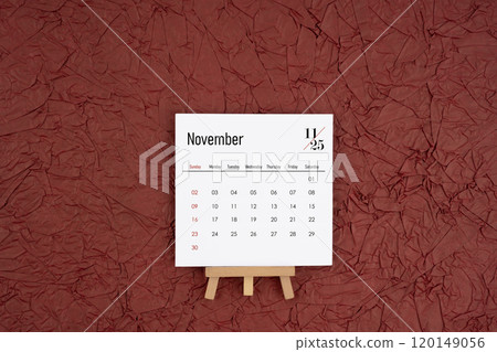 November 2025 calendar on red crumpled paper background. Directly above. 120149056