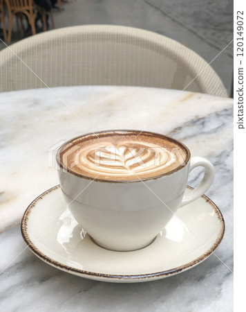 cappuccino coffee with latte art on marble table at cafe 120149072