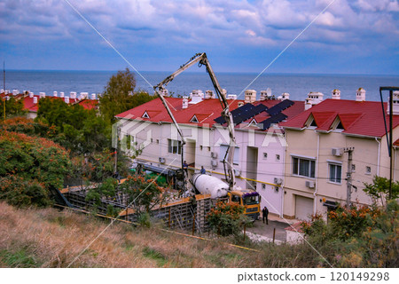 Construction of buildings on the slopes of Odessa. Uncontrolled development of the shores of the Odessa Gulf. Special equipment, a concrete pump and a mixer, are used. Construction of buildings on the slopes of Odessa. Uncontrolled development of the shores of the Odessa Gulf. Special equipment, a concrete pump and a mixer, are used. 120149298