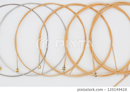 Guitar strings and white background Replacement strings for acoustic guitar 120149428