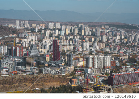 A bustling cityscape showcasing vibrant architecture and construction in an urban landscape during daylight hours 120149610
