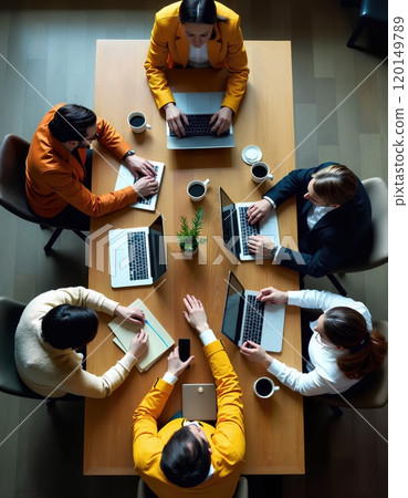 Collaborative business meeting with professionals in formal attire discussing strategy 120149789