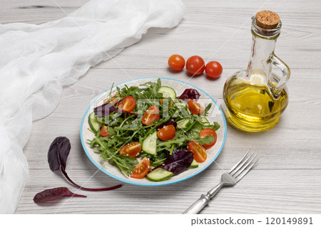 Vegetable salad of tomatoes, cucumbers, greens on the plate with ingredients. Vegetable salad of tomatoes, cucumbers, greens on the plate with ingredients. 120149891
