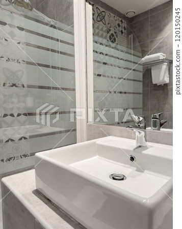 modern bathroom sink and faucet. Washbasin faucet in minimalist modern bathroom interior. 120150245