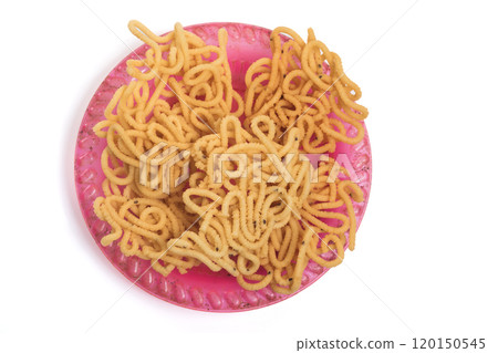 Traditional south indian crunchy murukku snack on plate isolated on white background. Top view. 120150545