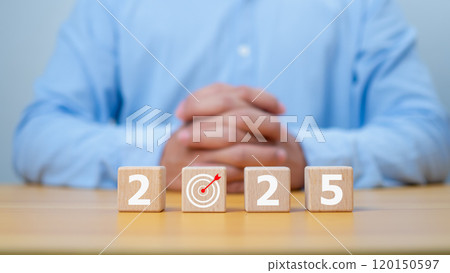 Businessman showing wooden cube from 2025. New year resolution, goal, plan, and action concept. Target plan and mission annual. Happy new year 2025 background with goal icon. 120150597