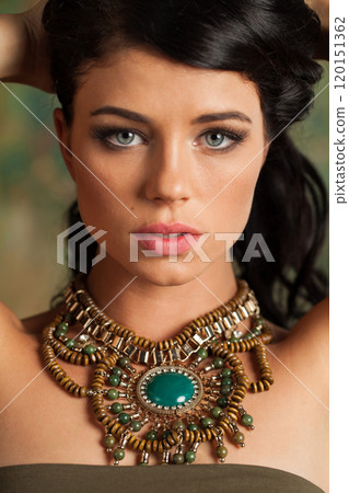 Fashion portrait of brunette woman posing in art studio. Young lady with long curly hair and make-up 120151362