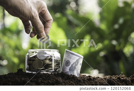 Hand with money coins in clear glass, Business investment growth concept, saving concept, Hand putting coin in clear jar. Hand with money coins in clear glass, Business investment growth concept, saving concept, Hand putting coin in clear jar. 120152068